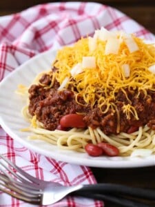 Cincinnati Chili served over spaghetti with beans, cheese and onions