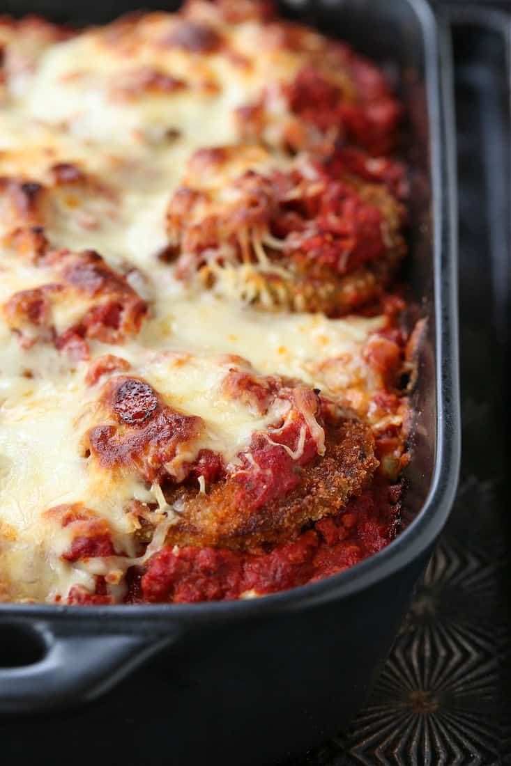 A closeup of the corner of an eggplant parmesan casserole.