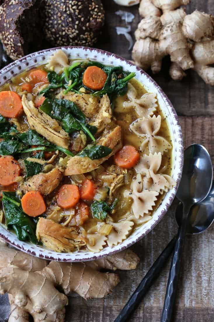 Chicken soup recipe with spoons and a napkin