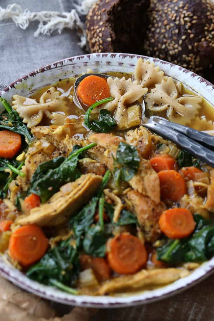 Detox Chicken Soup recipe in a bowl with two spoons