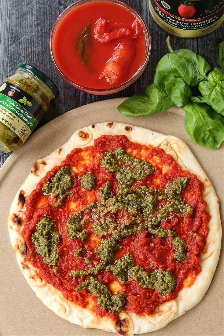 Pizza with sauce and basil pesto