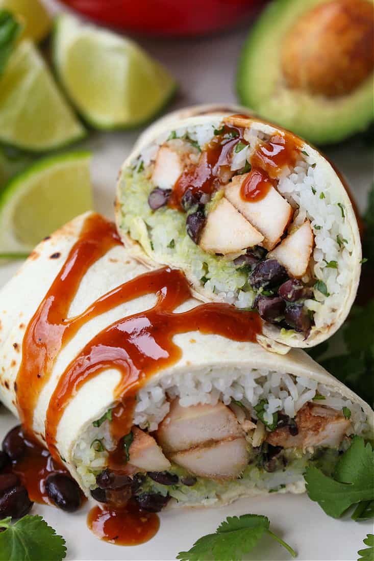 Teriyaki Chicken Burritos with sauce drizzled over the tops