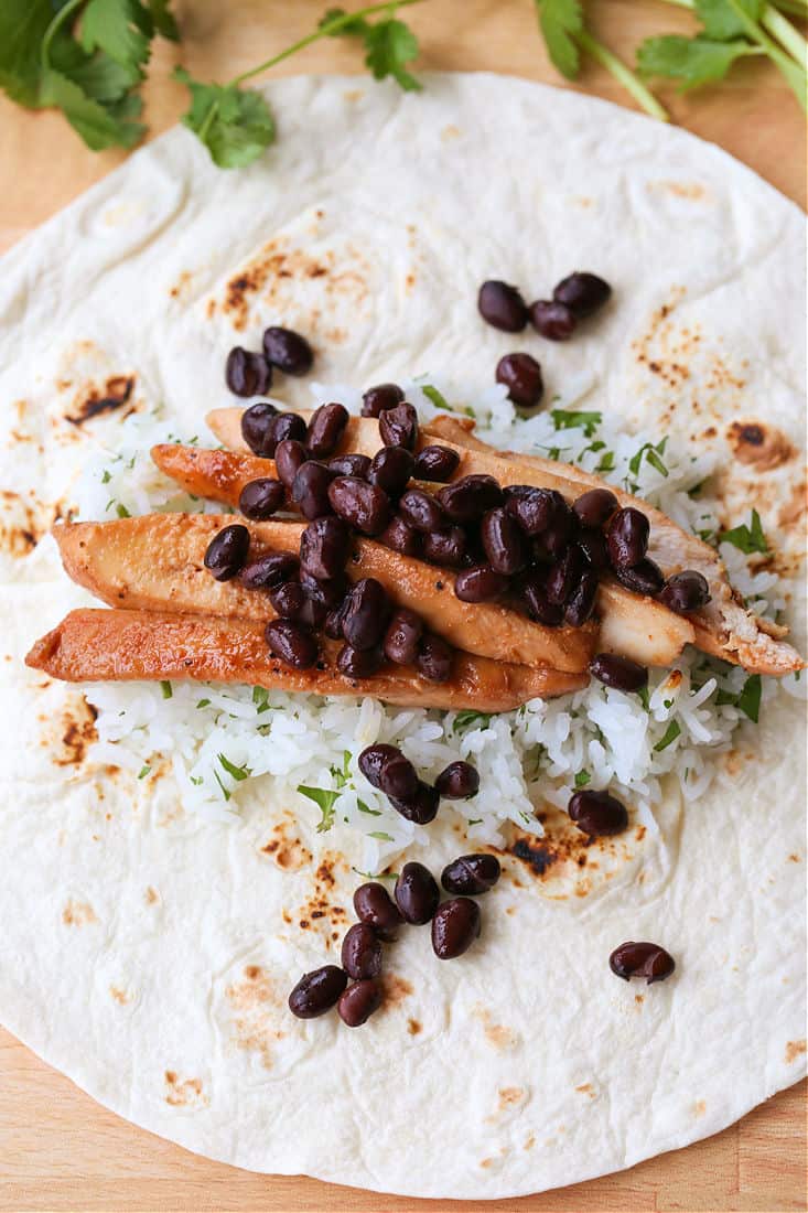 teriyaki chicken burritos being folded