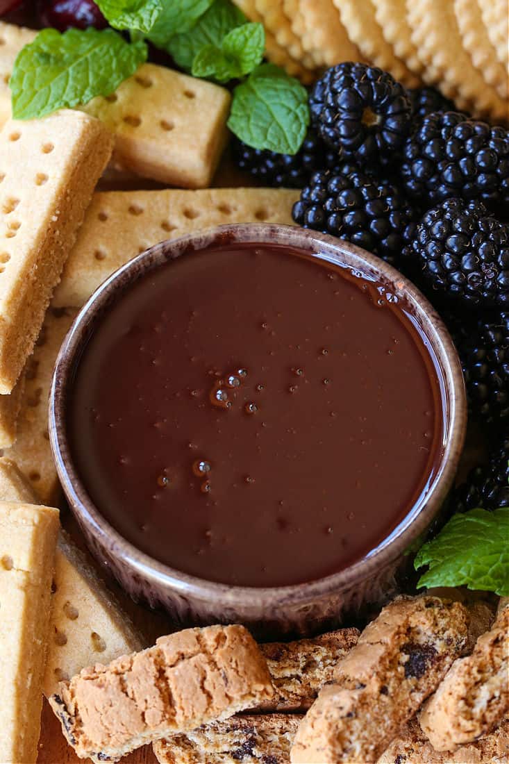 Chocolate Fondue Recipe in a bowl with fruit and cookies