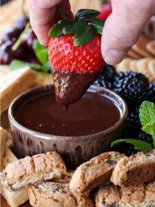 Strawberry being dipped into Chocolate Fondue