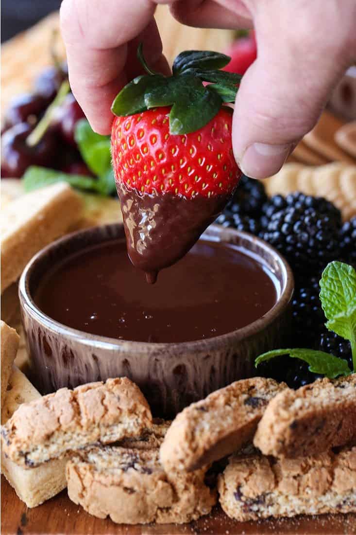 Strawberry being dipped into Chocolate Fondue