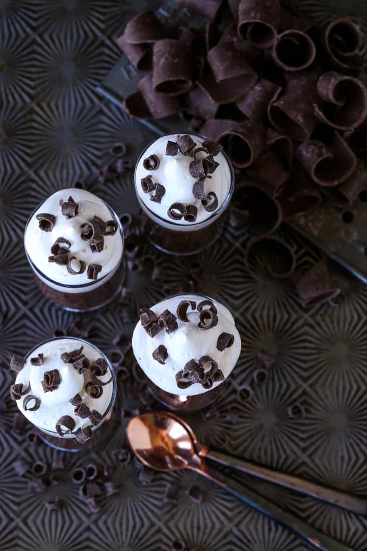 Chocolate Stout Pudding Shots for the beer lover in your life! A hint of flavor from chocolate stout, sweetened with a whipped cream topping! Chocolate stout pudding in shot glasses with whipped cream