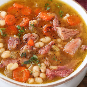 ham and bean soup in white bowl with napkin