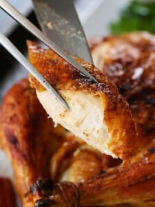 Slice of roast chicken on a serving fork
