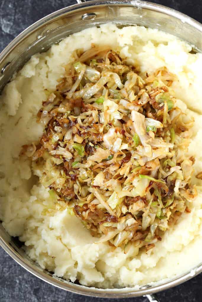 This Colcannon recipe is a St. Patrick's Day favorite! Creamy, buttery mashed potatoes blended with sweet caramelized onions and cabbage. mashed potatoes with cabbage and caramelized onions