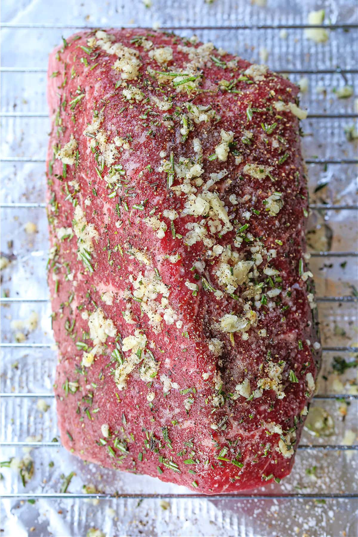 garlic and herb rubbed roast beef on oven rack