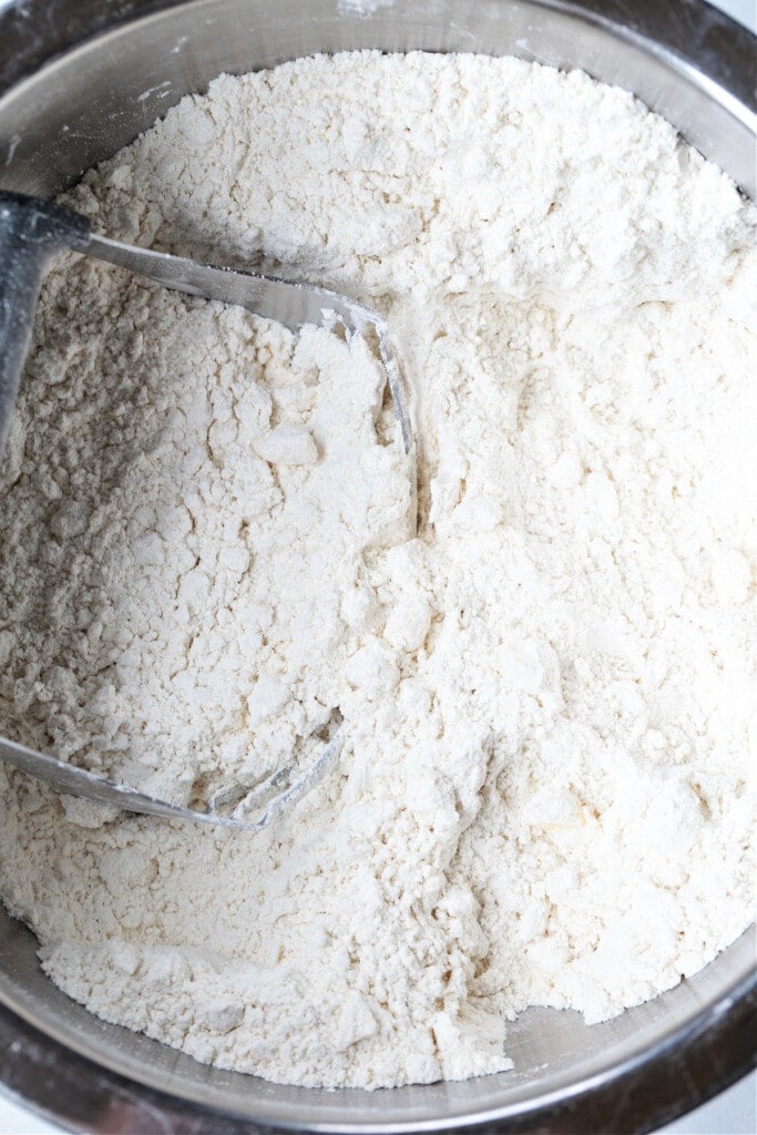 We love our slightly sweeter version of this classic Irish Soda Bread! Perfect for your St. Patrick's Day celebration, or as a homemade gift! cutting butter into flour for Irish soda bread