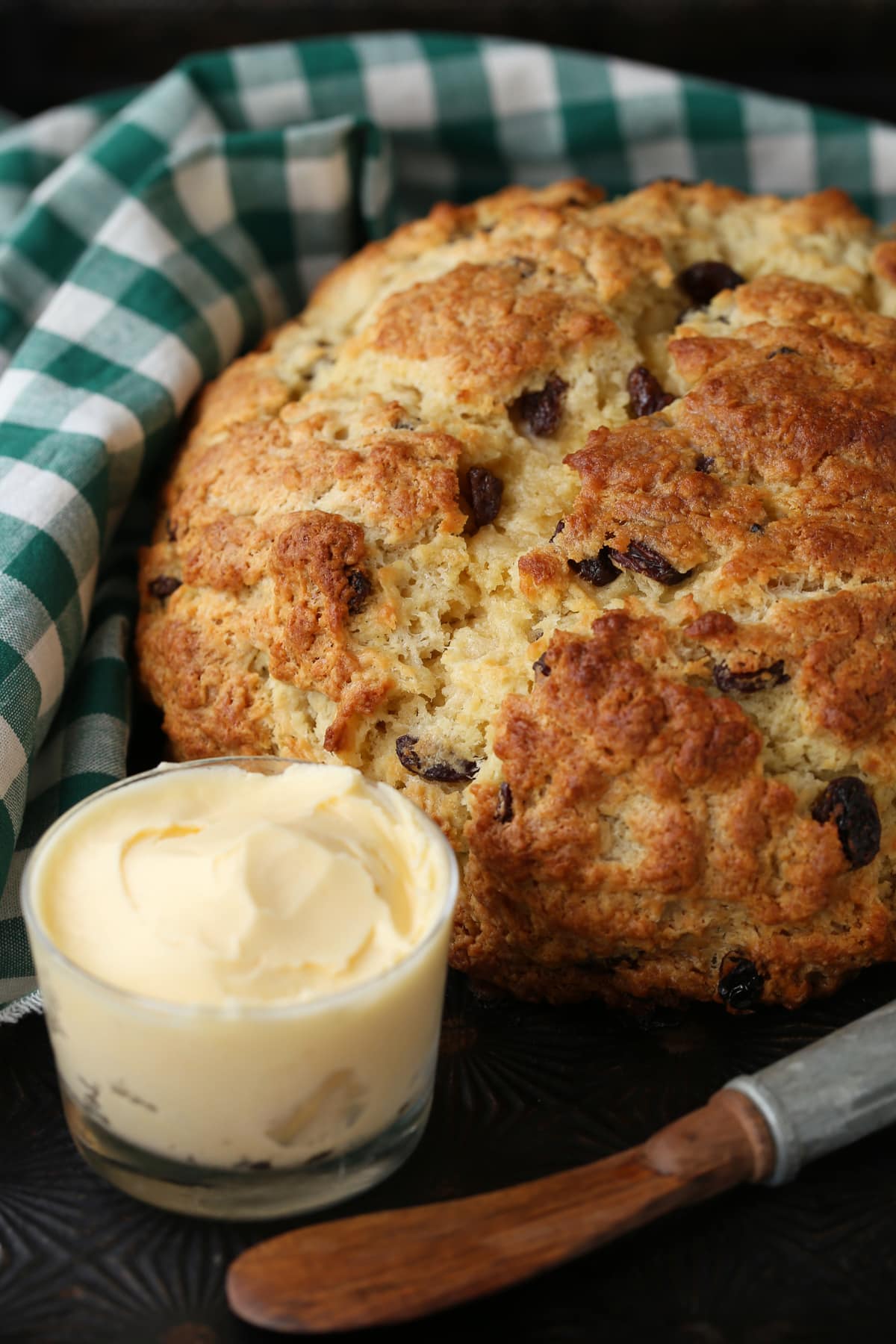 We love our slightly sweeter version of this classic Irish Soda Bread! Perfect for your St. Patrick's Day celebration, or as a homemade gift! Irish Soda Bread with green and white napkin and butter