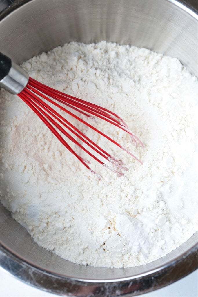 We love our slightly sweeter version of this classic Irish Soda Bread! Perfect for your St. Patrick's Day celebration, or as a homemade gift! dry ingredients in bowl with whisk
