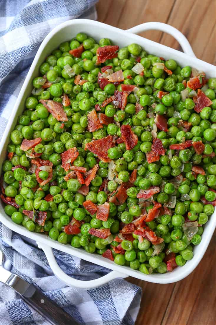 Peas with bacon in a serving dish