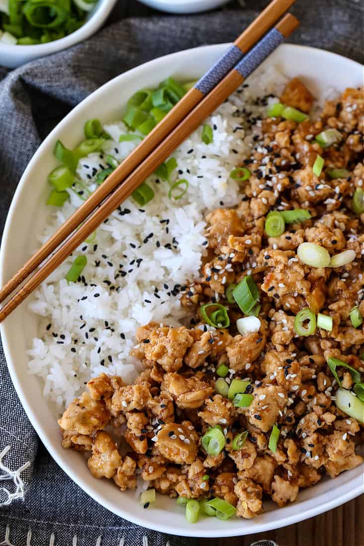 Ground Sesame Chicken in a bowl with chop sticks