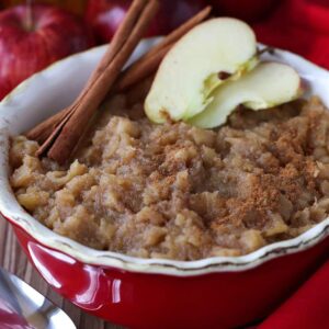 Homemade Bourbon applesauce in a red bowl with spoon