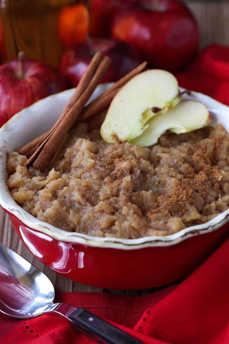 Homemade Bourbon applesauce in a red bowl with spoon