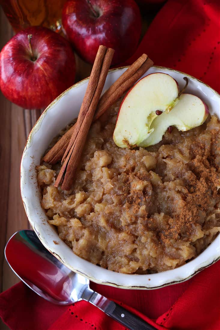 Bourbon applesauce in a red bowl with sliced apples