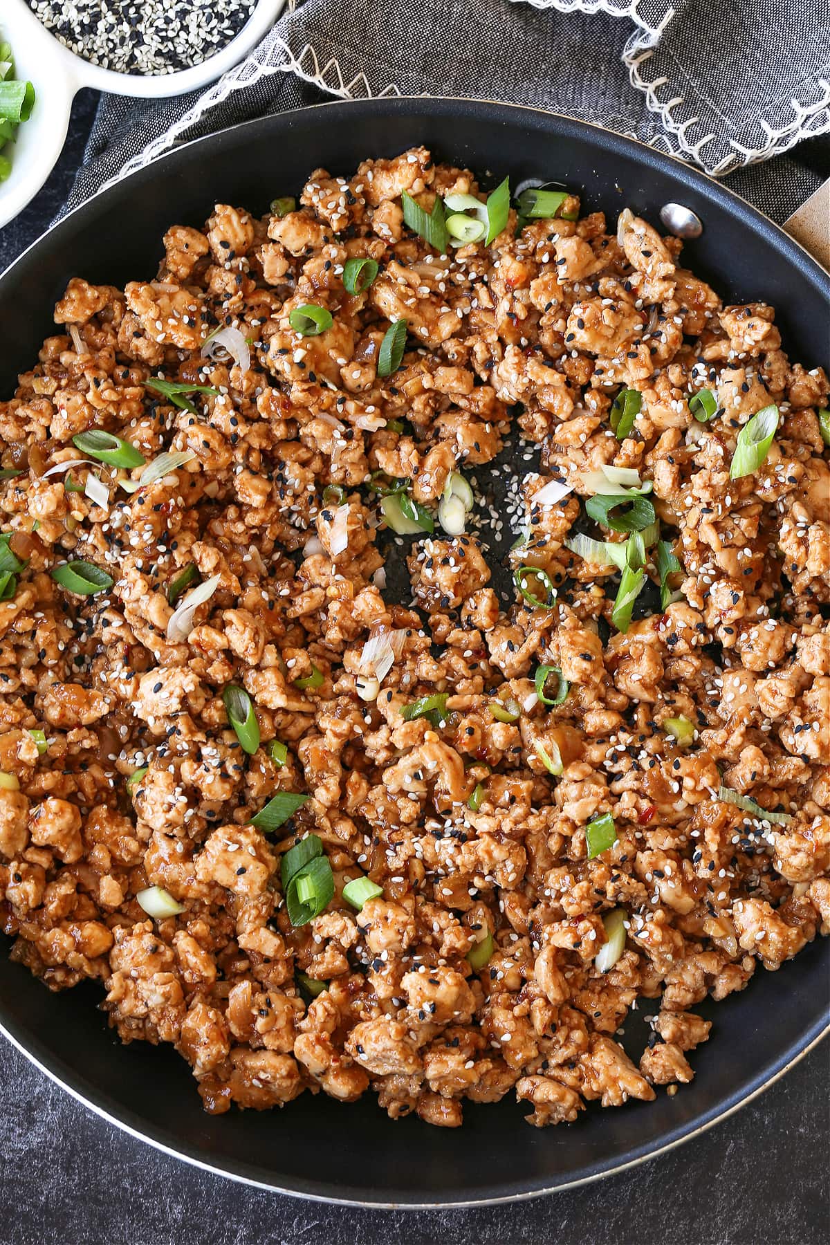 ground chicken with sesame sauce and scallions in skillet