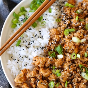 ground chicken recipe in a bowl with rice and chopsticks on the side