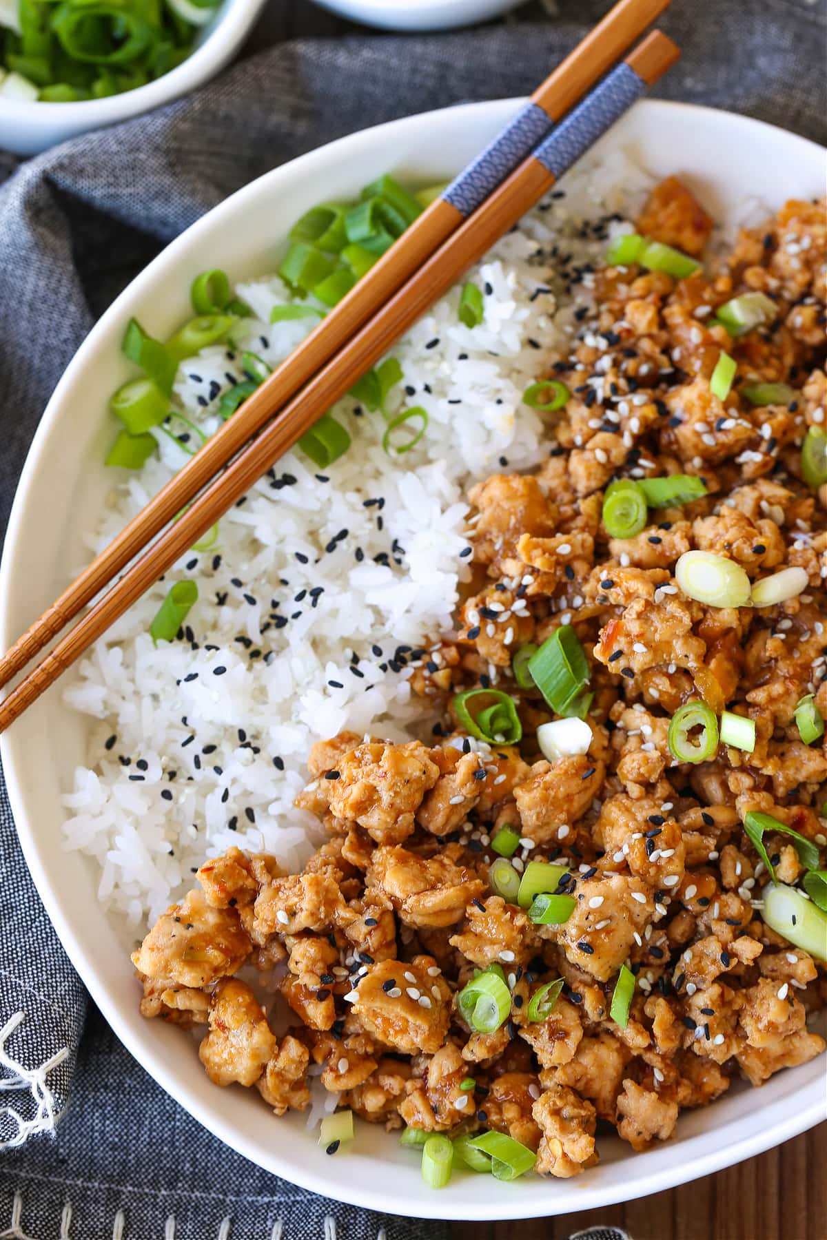 ground chicken recipe in a bowl with rice and chopsticks on the side