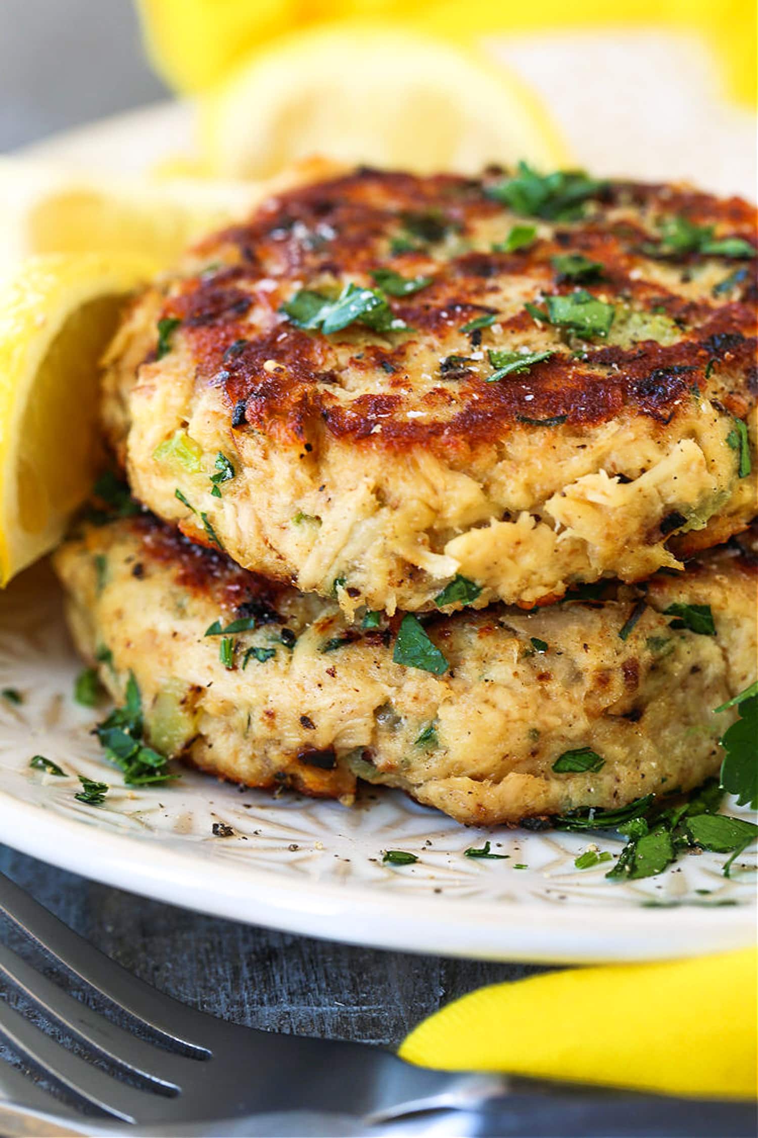 tuna cakes made with canned tuna stacked on a plate