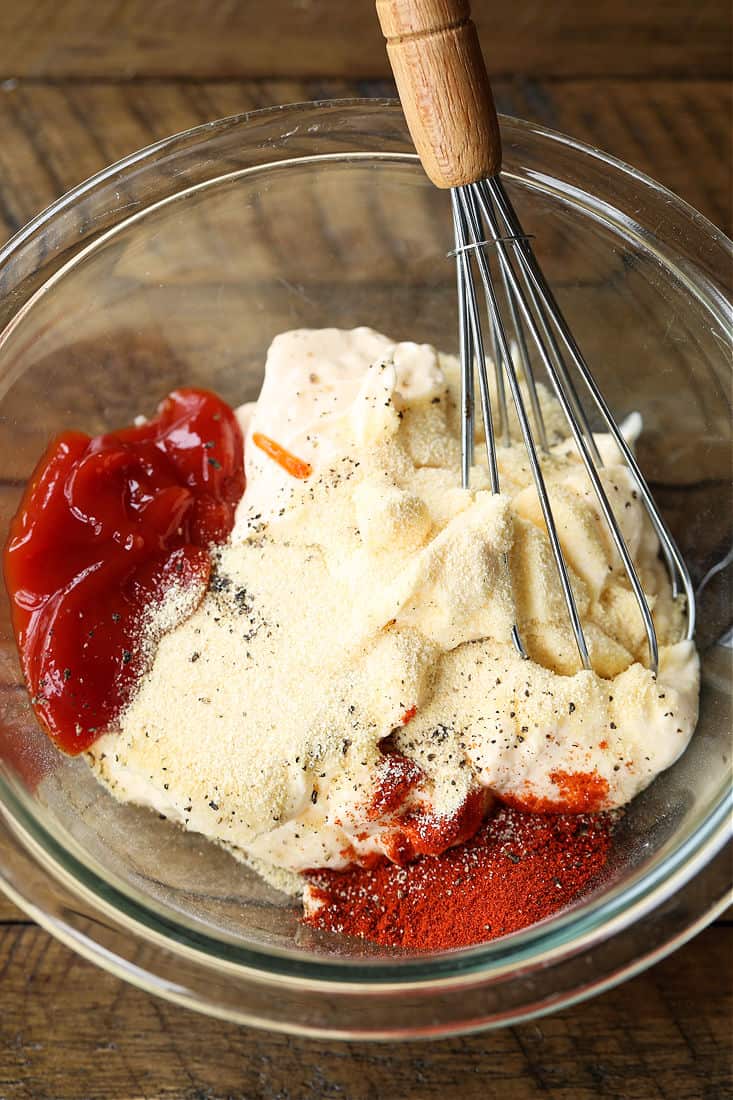 Ingredients for sauce recipe in a bowl with wisk