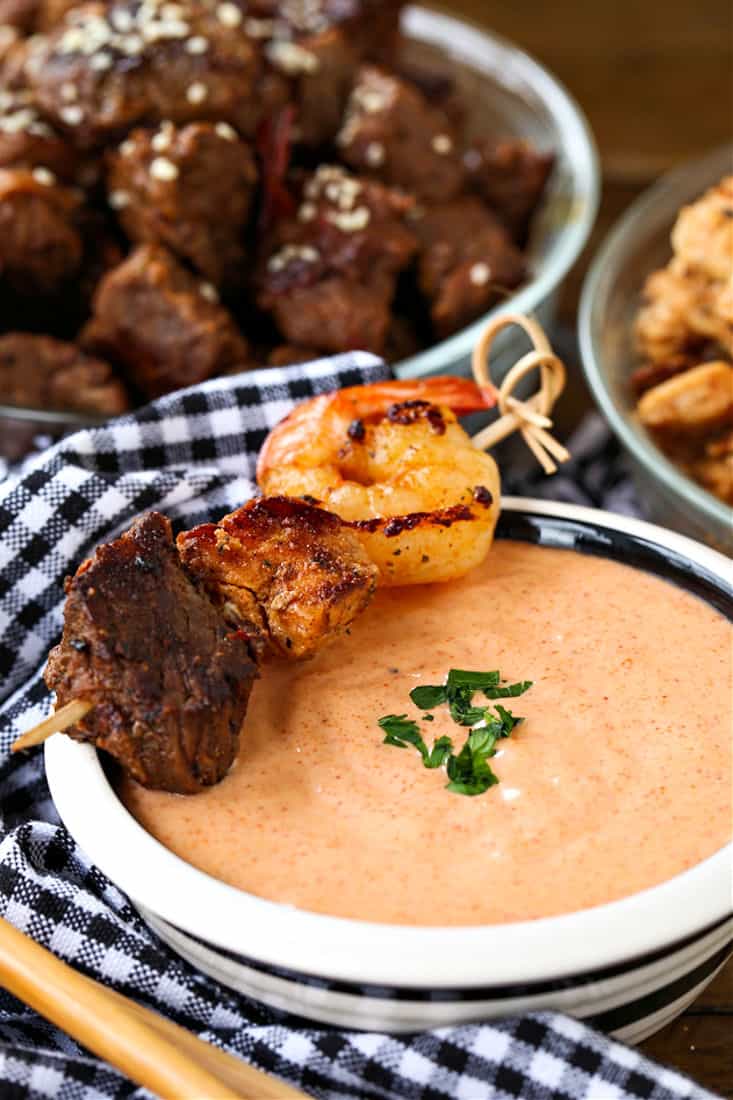 Yum Yum Sauce in a bowl with steak, shrimp and chicken