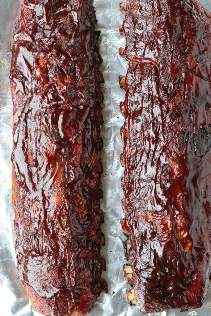 bbq ribs with sauce on a pan with foil