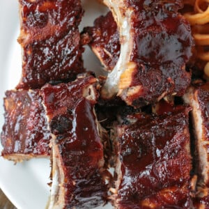 bbq ribs stacked on a plate with fries