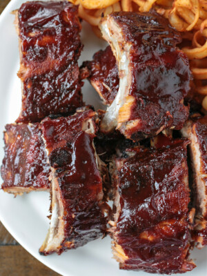bbq ribs stacked on a plate with fries