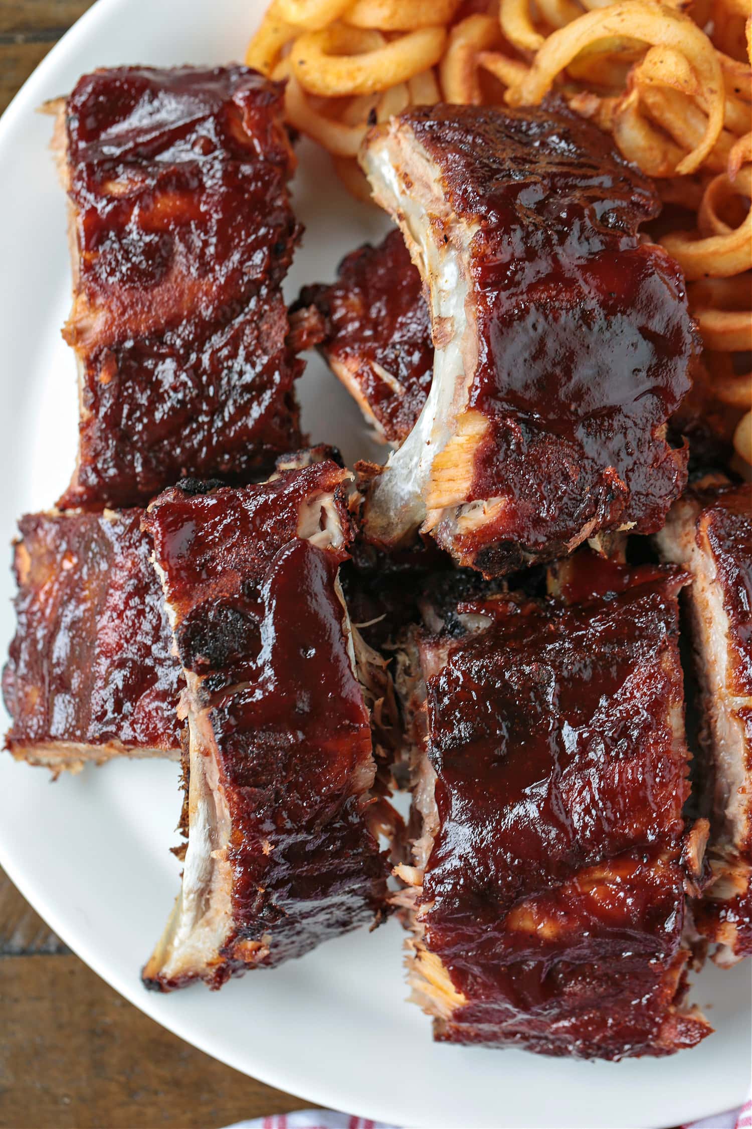 bbq ribs stacked on a plate with fries