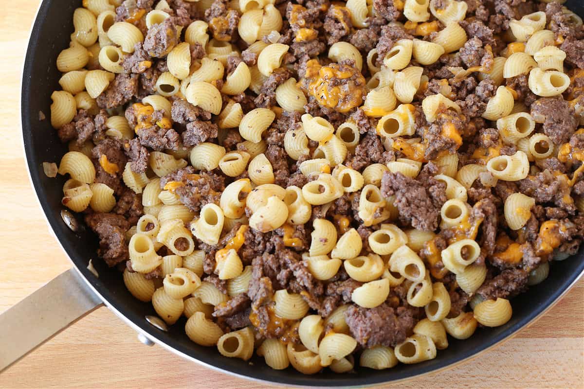 Get ready to dive into this creamy, beefy, cheesy Cheeseburger Pasta! The ultimate comfort food dinner that's ready in under 30 minutes! pasta, ground beef and cheese mixed in a skillet