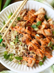 diced chicken on a plate with yum yum sauce and chop sticks