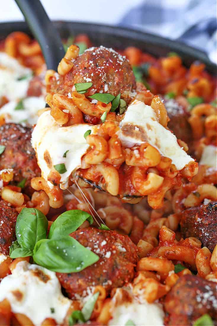 meatballs, pasta and mozzarella cheese on a spoon