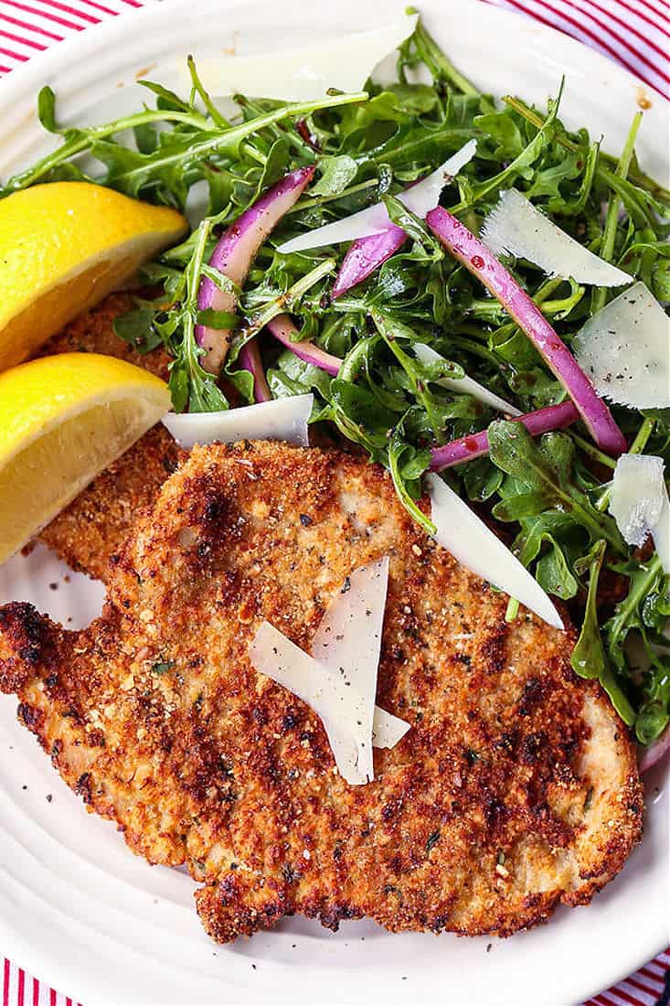 Breaded turkey cutlets on a plate with salad