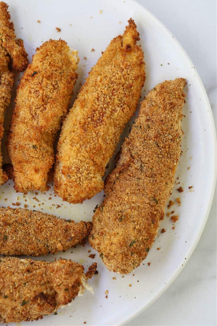 These Air Fryer Chicken Tenders are so crispy on the outside and juicy on the inside! Make in large batches and then freeze for an easy meal! Air Fryer Chicken Fingers on a plater