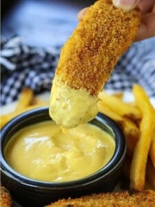 Chicken Fingers dipping into honey mustard sauce