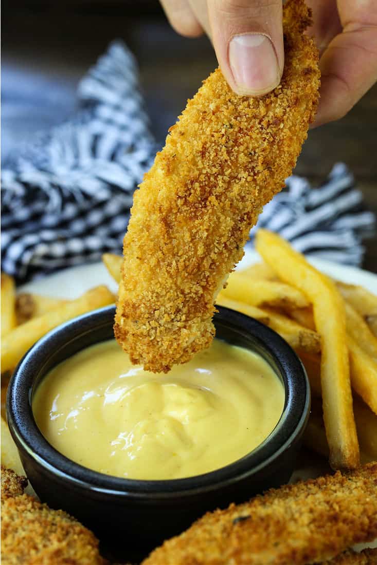 These Air Fryer Chicken Tenders are so crispy on the outside and juicy on the inside! Make in large batches and then freeze for an easy meal! Air Fryer Chicken Tender with honey mustard sauce
