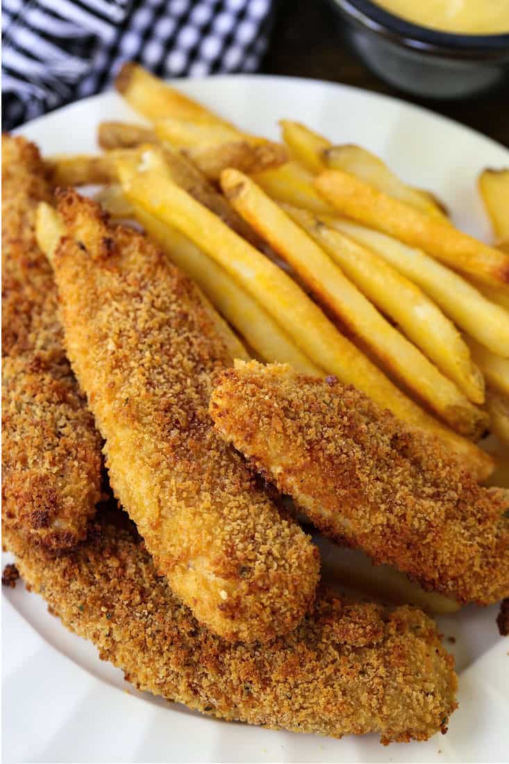 chicken fingers on a plate with french fries