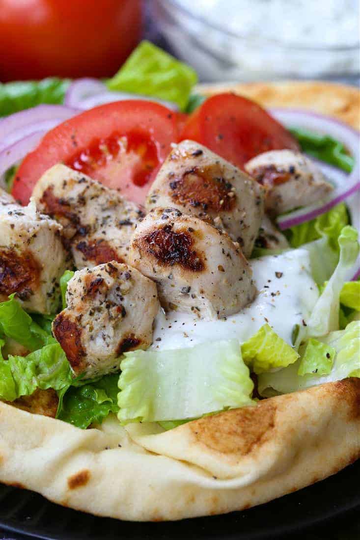 Grilled, marinated chicken on pita bread with fresh vegetables