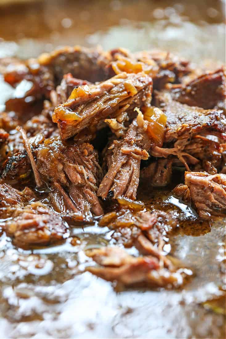 Shredded beef in gravy with onions in a crock pot