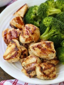 grilled chicken nuggets on a plate with broccoli