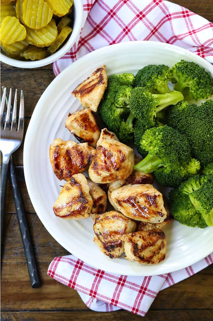 Grilled chicken nuggets on a dinner plate with forks