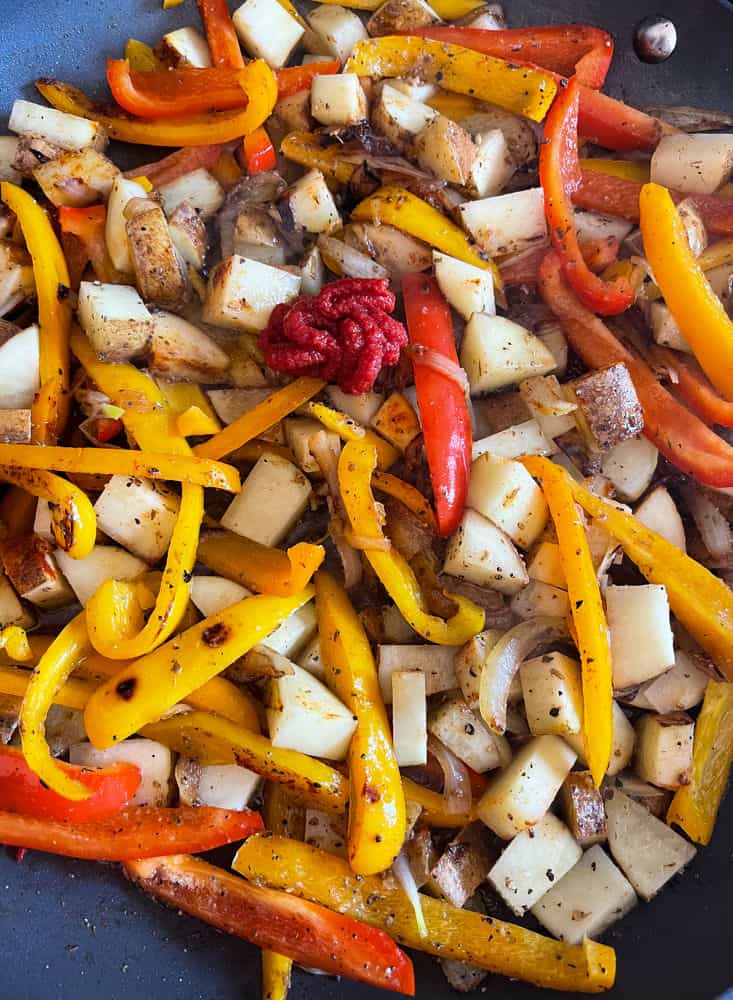 Italian sausage, peppers, onios and potatoes with tomato paste and marsala wine