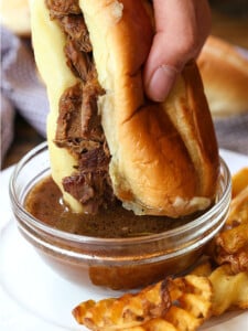 french dip sandwich dipping in au jus