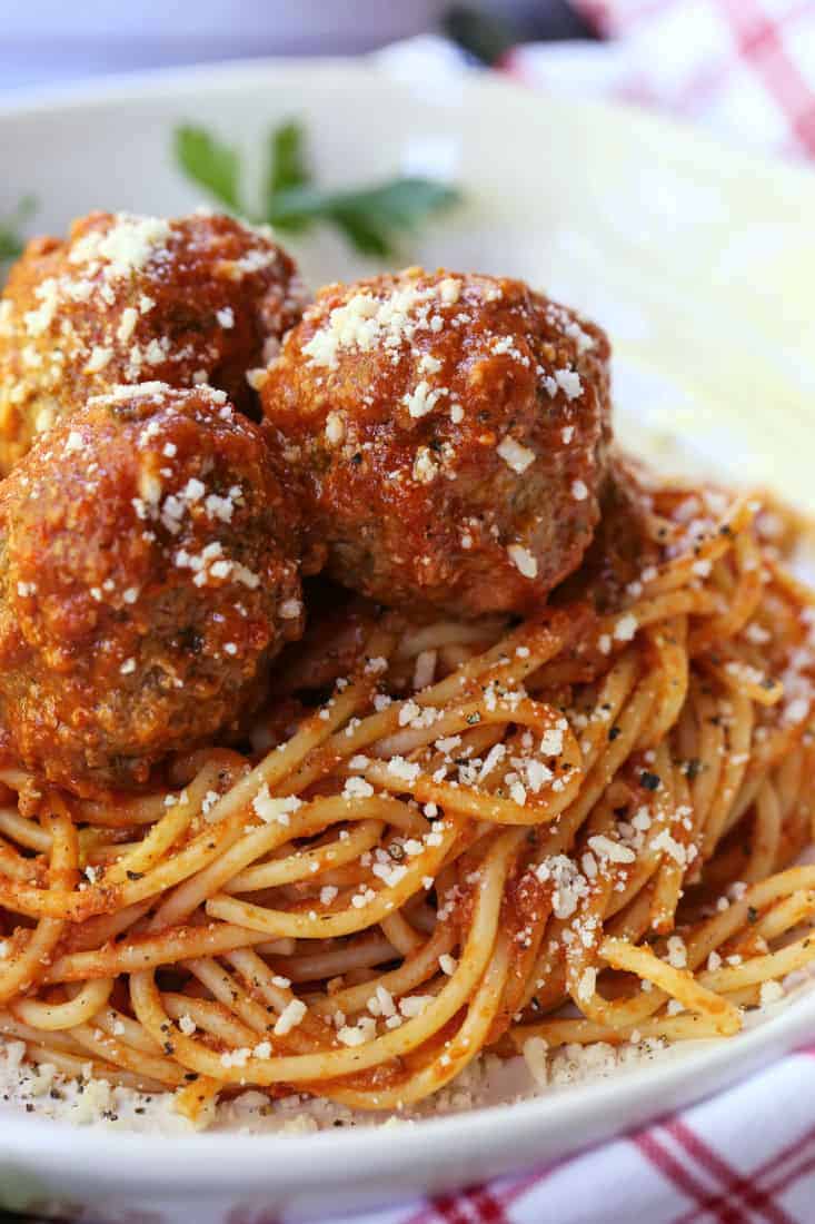 This Slow Cooker Meatballs recipe is the perfect way to have a comfort food dinner even on busy nights! Just cook the pasta and dinner is done! Slow Cooker meatballs on top of spaghetti