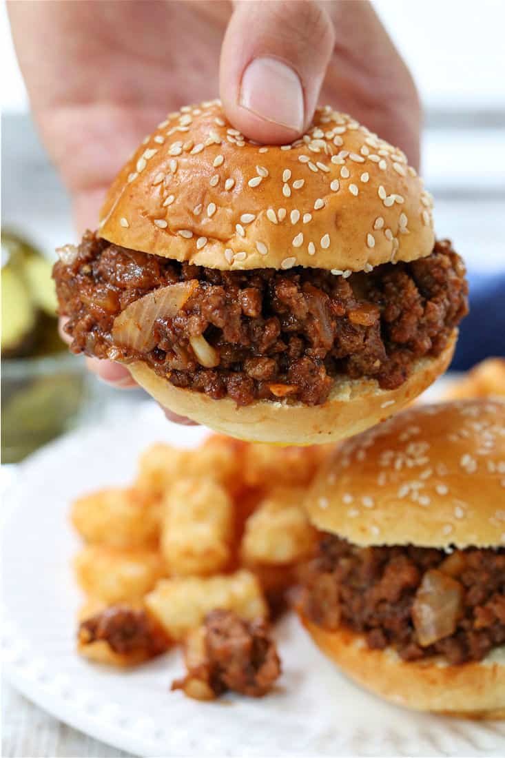 Cafeteria Sloppy Joes being held in hand