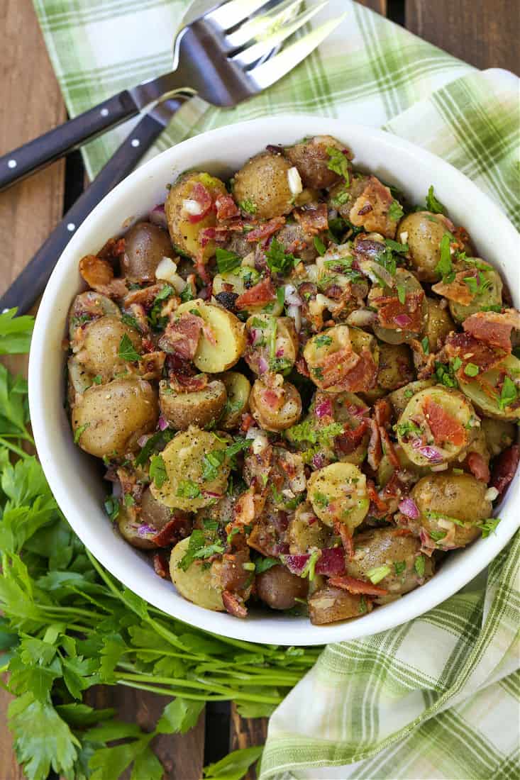 German Potato Salad in a serving bowl with napkin